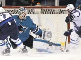  ?? NHAT V. MEYER/STAFF ?? Sharks goaltender Martin Jones makes a save against the Jets’ Drew Stafford.