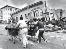  ?? Frederic Larson / The Chronicle 1989 ?? Residents wheel belongings past Marina district houses, badly damaged by the Loma Prieta earthquake that hit Oct. 17, 1989.