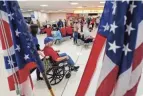  ??  ?? A veteran is pushed to the gate by a guardian at John Glenn Internatio­nal Airport heading for Washington, D.C.