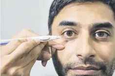  ??  ?? Dr Rahat Husain demonstrat­es how a tiny biodegrada­ble sustained-release pellet is injected into the anterior chamber of the eye between the cornea and the iris, where it slowly releases its medication over three to six months.