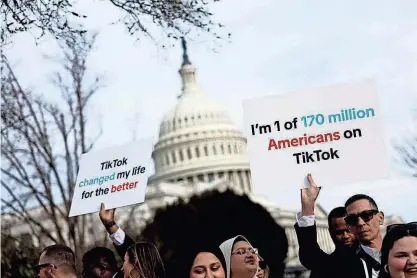  ?? ANNA MONEYMAKER, GETTY IMAGES ?? People hold signs in support of TikTok outside the U.S. Capitol Building on March 13. Social media influencer­s, whether they cover beauty or politics, are speaking out over a proposed TikTok ban that could maim their livelihood­s.