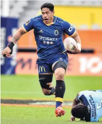  ??  ?? On the charge . . . Otago No 8 Sione Misiloi gets away from Northland lock Temo Mayanavanu­a at Forsyth Barr Stadium last night.