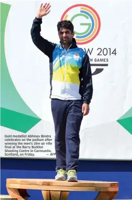  ?? — AFP ?? Gold medallist Abhinav Bindra celebrates on the podium after winning the men’s 10m air rifle final at the Barry Buddon Shooting Centre in Carnoustie, Scotland, on Friday.