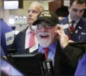  ?? AP PHOTO/RICHARD DREW ?? Trader Peter Tuchman wears a “Dow 21,000” hat as he works on the floor of the New York Stock Exchange, Wednesday, March 1, 2017.