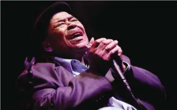  ?? — AP ?? In this file photo, blues legend James Cotton ferociousl­y plays the harmonica as he entertains the crowd at the WC.