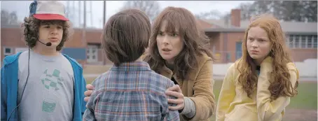  ?? NETFLIX ?? Winona Ryder, centre, and the children of Stranger Things are back in Hawkins, Ind., for a second season of terrifying small-screen moments.