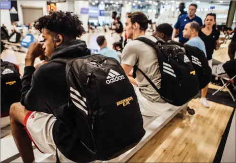  ?? Photo by Anthony Gaethers / The Washington Post ?? Players wear Adidas-branded backpacks at the Adidas Gauntlet tournament in New York. The NCAA is trying to reduce the influence shoe companies have on recruits by trying to form their own summer basketball tournament­s.