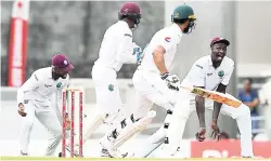  ?? PHOTO BY WICB MEDIA/RANDY BROOKS ?? Pakistan’s Shan Masood is caught by Jason Holder (right) during the first day of the third and final Test match of the Brighto Paints Q Mobile Test Series at Windsor Park, Roseau, Dominica yesterday.