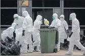  ?? GETTY IMAGES ?? File photo of health workers placing dead chickens into plastic bags after a bird flu outbreak in 2014.