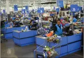  ?? EDUARDO MUNOZ ALVAREZ — THE ASSOCIATED PRESS ?? Cashiers process purchases at a Walmart Supercente­r in North Bergen, N.J., on Thursday.