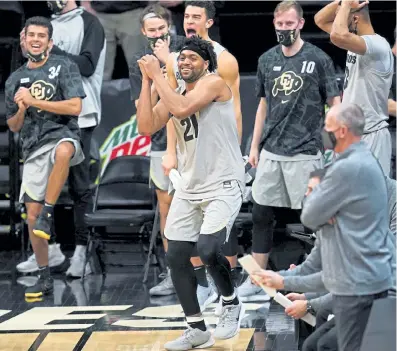  ?? David Zalubowski, The Associated Press ?? CU forward Evan Battey, front, jokes with teammates as time runs out Thursday night.