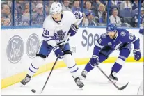  ?? CP PHOTO ?? In this March 20 file photo, Toronto Maple Leafs forward William Nylander (29) gets past Tampa Bay Lightning defenceman Braydon Coburn (55) during NHL in Tampa, Fla. Nylander remains an unsigned restricted free agent as the Maple Leafs prepare to start their training camp this week.