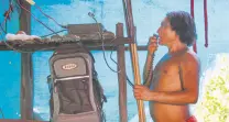  ??  ?? A Waiapi man uses a solar amateur radio to talk to another village at the Waiapi indigenous reserve.