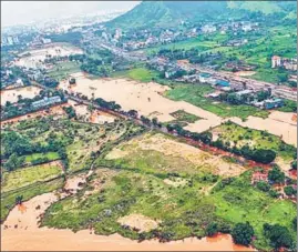  ??  ?? An inundated area in Maharashtr­a’s Raigad after heavy rain; and (right) submerged vehicles in north Goa’s Satari on Friday.