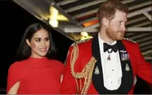  ?? Simon Dawson/Pool via AP ?? Buckingham Palace confirmed Friday that Prince Harry and his wife, Meghan, will not be returning to royal duties, and Harry will give up his honorary military titles.