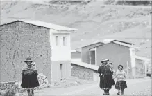  ??  ?? Women walk near to the route to Rainbow Mountain. The flood of tourists to see the recently-discovered mountain has meant jobs and hard cash for the local Pampachiri indigenous community, which has struggled with high rates of alcoholism, malnutriti­on...