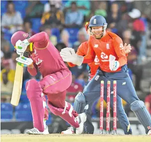  ??  ?? Sheldon Cottrell (L) of West Indies is bowled as Jonny Bairstow (R) of England celebrates during the 2nd T20I between West Indies England at Warner Park, Basseterre, Saint Kitts and Nevis. - AFP photo