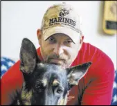  ?? JEFF SCHEID/LAS VEGAS REVIEW-JOURNAL FOLLOW @JLSCHEID ?? Iraq War Marine veteran Jason Brooks sits with his service dog Charlie on Thursday in his Henderson home.