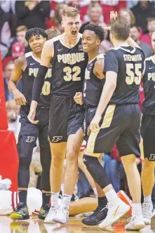  ?? DOUG MCSCHOOLER/ASSOCIATED PRESS ?? Purdue center Matt Haarms, center, reacts with his teammates after drawing a charging foul against Indiana during Saturday’s game in Bloomingto­n, Ind. Purdue won 74-62.