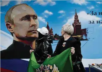  ?? Foto: AFP ?? Die Präsidents­chaftswahl­en in Russland kennen schon vor Auszählung der Stimmen nur einen Sieger: Wladimir Putin.