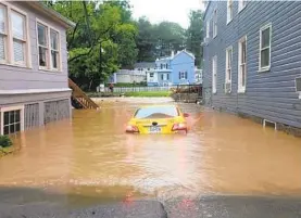  ?? KEVIN RECTOR/BALTIMORE SUN ?? Police and fire emergency crews search submerged cars for trapped occupants. Officials said no fatalities or missing people had been reported as of Sunday evening.