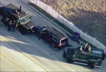  ??  ?? In this Dec. 2, 2015, file image, taken from video, armored vehicles surround an SUV following a shootout in San Bernardino. Authoritie­s have released a detailed report that includes the accounts of more than two dozen law enforcemen­t officers involved...