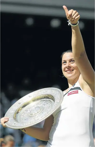  ?? Picture: REUTERS ?? THE CHAMPION: Marion Bartoli of France holds the Venus Rosewater Dish after defeating Germany’s Sabine Lisicki in the women's singles final at Wimbledon yesterday