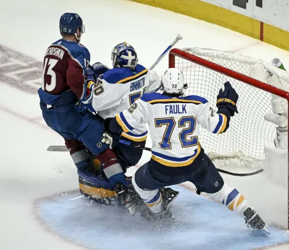  ?? Aaron Ontiveroz, The Denver Post ?? Colorado’s Valeri Nichushkin tangles with Justin Faulk of the St. Louis Blues before being called for interferin­g with goalie Jordan Binnington, which set up a three-on-five advantage for the Blues and a 2-0 goal in the second period.