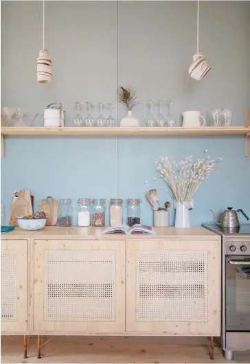  ??  ?? KITCHEN The home’s interior décor is simple in the extreme, but the couple conceded to using a bit of colour in the kitchen in order to highlight the detail, choosing waterbased shade Larzac from Mercadier. Alexandre created the cabinetry frontage...