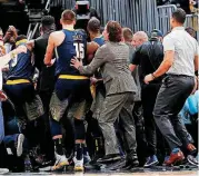  ?? [AP PHOTO] ?? Members of the Denver Nuggets surround Gary Harris after he hit a buzzer-beating shot on Thursday night against the Oklahoma City Thunder. OKC came back from a big deficit to tie the game -- only to lose 127-124.