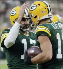  ?? AARON GASH — THE ASSOCIATED PRESS ?? Green Bay Packers’ Aaron Rodgers, left, is congratula­ted by
Allen Lazard after throwing career touchdown pass 443during Saturday’s win over the Cleveland Brown which broks the previous franchise record held by Brett Favre. Rodgers ended the game 445career TD passes, fifth on the NFL’S all-time list.