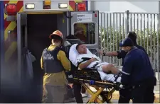  ?? RICK MCCLURE VIA AP ?? Medical personnel load an injured person into an ambulance outside Saugus High School in Santa Clarita after a student gunman opened fire at the school on Thursday.