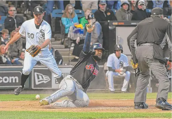  ??  ?? Abraham Almonte watches umpire Jerry Layne make the call after he scores as Mike Pelfrey tries to retrieve the ball in the fifth inning. | MATT MARTON/ AP