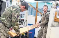  ??  ?? Engineers from 24 Commando Royal Engineers carry out repairs yesterday to make Balsam Ghut jail secure