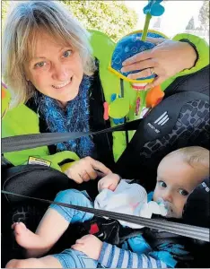  ??  ?? Ann Hatch checks that Conor Perrett is safe and sound in his car seat.