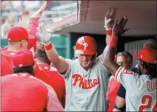  ?? JOHN MINCHILLO — THE ASSOCIATED PRESS ?? Cincinnati Reds’ Rhys Hoskins celebrates in the dugout after hitting a two-run home run off Cincinnati Reds starting pitcher Matt Harvey in the fourth inning of a baseball game earlier this season.