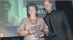  ??  ?? SUPPORTER OF THE YEAR Joan Horton, a stalwart of grassroots netball for over three decades, receives her award from Mark Storey, chief football writer at The News