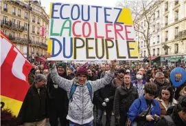  ?? ASSOCIATED PRESS ?? Protesters hold a placard reading “Listen to the anger of the people” during a demonstrat­ion against plans to push back France’s retirement age.