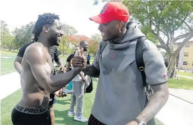  ?? JOE CAVARETTA/SOUTH FLORIDA SUN SENTINEL PHOTOS ?? Free agent Antonio Brown, left, greets Redskins quarterbac­k Dwayne Haskins on Wednesday at Holiday Park in Fort Lauderdale.