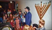 ?? CHRIS HUNT PHOTOGRAPH­Y ?? Rabbi Eliyahu Schusterma­n has a short quiz with the children on meanings of the season just prior to the menorah lighting in December 2019 sponsored by Chabad Intown and MJCAA Day Camps.
