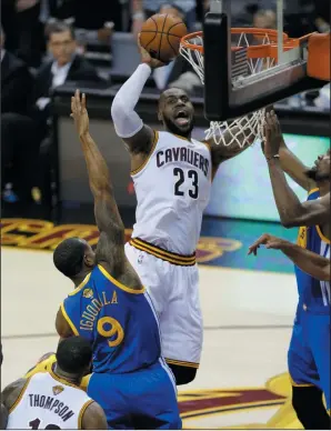  ?? AP PHOTO/TONY DEJAK ?? Cleveland Cavaliers forward LeBron James (23) shoots between Golden State Warriors forward Andre Iguodala (9) and Warriors' Kevin Durant during the second half of Game 4 of basketball's NBA Finals in Cleveland, Friday. Cleveland won 137-116.