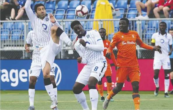  ?? David Bloom ?? FC Edmonton’s Ramon Soria puts the boots to teammate Mele Temguia during Canadian Premier League action against the visiting Forge FC of Hamilton on Wednesday nigh at Clarke Field. The Eddies wore white for the first time at home and came away with a 1-0 decision.