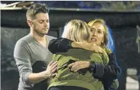  ?? MARK WALLHEISER/GETTY ?? Matthew Rodin and Susan Turner comfort Melissa Hutchinson, who rendered aid to some of the victims of the shooting.