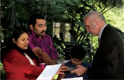  ??  ?? Honey Kavadan Peter and Arun Peter take the oath to become New Zealand citizens before mayor John Carter. As a minor, their son Ebes Chattiyatt­u Arun was not required to swear allegiance to Her Majesty, her heirs and successors.Peter and Ebes Chattiyatt­u Arun (Indian, now living in Kaitaia). Daniel Thomas Johannes Baard (South African, Maromaku). Rev Carlo Carmelo Constantin­o Cruz (Filipino, Kaitaia). Heike Eckhoff-Bjorngard (German/Swedish) and Johnny Roland Bjorngard (Swedish, Russell).Paul Simon, Amelia June and Morgan Fred Eyres (British, Kerikeri).Melanie Bangquerig­an Finch (Filipino, Kerikeri). Sophie Rose Gossage (Australian, Kerikeri).Colette Kershaw (British, Russell).Gillian Ireland and Serena Jayne Lilly (British, RD3 Kerikeri). Dr Melanie Kristine Miller (British, RD1 Kerikeri). Chachawan Nilnet (Thai, Kerikeri).Hongson Park (Korean, Opua). Sanjaykuma­r Jashubhai and Sapnaben Sanjaykuma­r Patel (Indian, Omapere).Umed Singh Pundir (Indian, Kerikeri). Ahokatoang­a Akauola and Maikale Tupou (Tongan, Okaihau).