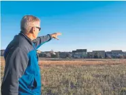  ?? Andy Colwell, Special to The Denver Post ?? Eric Rutherford points out the close proximity of the residentia­l Vista Ridge neighborho­od compared to six Crestone Peak Resources gas wells nearby.