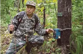  ?? AFP PIC ?? Liang Fengen, a ranger at the Nuanquan River Forestry Centre, showing a heat sensor camera as he surveys a forest near Suiyang town in Heilongjia­ng in August.