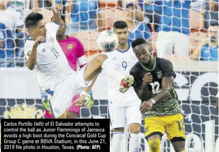  ?? (Photo: AFP) ?? Carlos Portillo (left) of El Salvador attempts to control the ball as Junior Flemmings of Jamaica avoids a high boot during the Concacaf Gold Cup Group C game at BBVA Stadium, in this June 21, 2019 file photo in Houston, Texas.