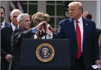  ?? VAN VUCCI — THE ASSOCIATED PRESS ?? Dr. Anthony Fauci, director of the National Institute of Allergy and Infectious Diseases, speaks on the coronaviru­s March 13, 2020, with President Donald Trump in the Rose Garden at the White House.