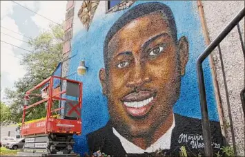  ?? Sarah Blake / Associated Press ?? A mural pays homage to Ahmaud Arbery in Brunswick, Ga., where the 25-year-old man was shot and killed in February 2020. The man who fatally shot Arbery took the witness stand to tell jurors he pulled the trigger fearing for his own life.