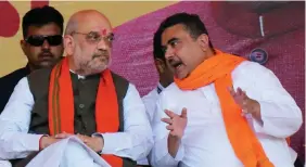  ?? ?? Union Home Minister Amit Shah interactin­g with Leader of the Opposition in West Bengal Assembly Suvendu Adhikari during a public meeting, at Suri, in Birbhum on 15 April. ANI